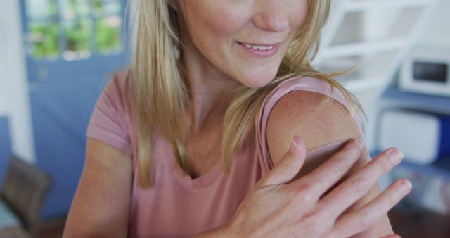 Smiling Woman Applying Sunscreen to Arm at Home - Download Free Stock Images Pikwizard.com