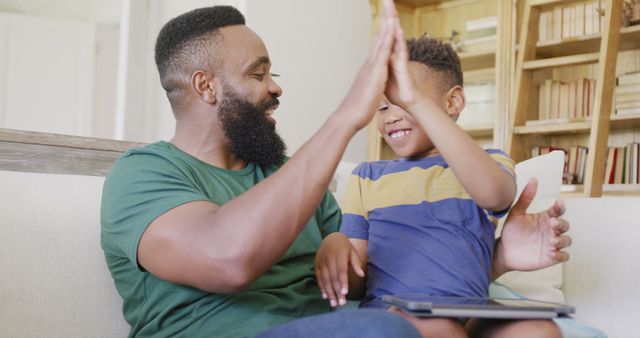 Happy Father and Son Giving High Five at Home - Download Free Stock Images Pikwizard.com