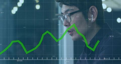 Asian Analyst Analyzing Financial Data with Green Line Chart Overlay in Office