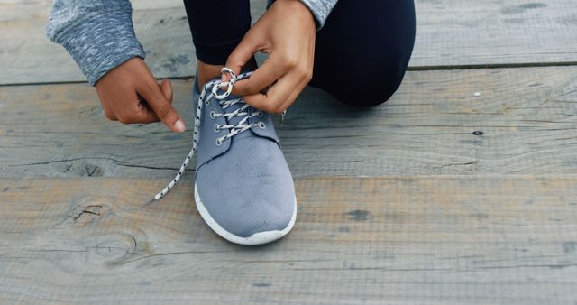 Low section of woman tying her shoes lace 4k