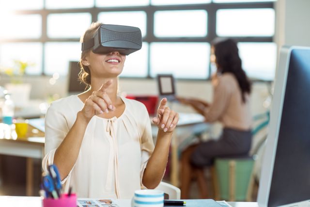This image is ideal for illustrating the use of advanced technology in creative industries. It can be used in articles or advertisements related to virtual reality, graphic design, modern workspaces, and innovation in the workplace. Perfect for showcasing the integration of VR in professional settings and promoting tech-forward business environments.