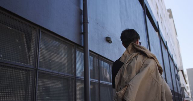 Man Walking by Building Carrying Jacket - Download Free Stock Images Pikwizard.com