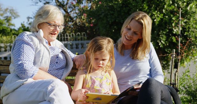 Three Generations Enjoying Story Time on Sunny Day - Download Free Stock Images Pikwizard.com