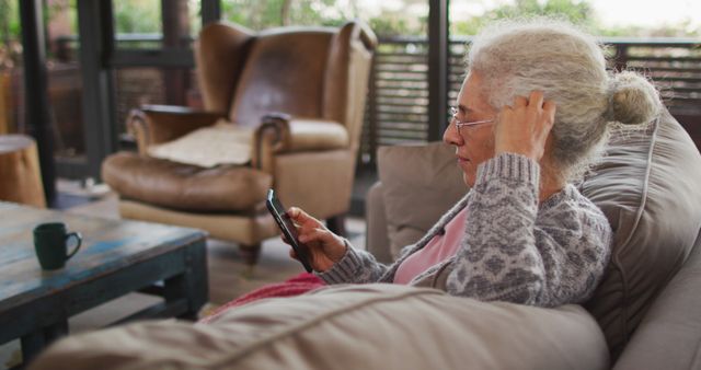 Senior Woman Using Smartphone at Home in Comfortable Living Room - Download Free Stock Images Pikwizard.com