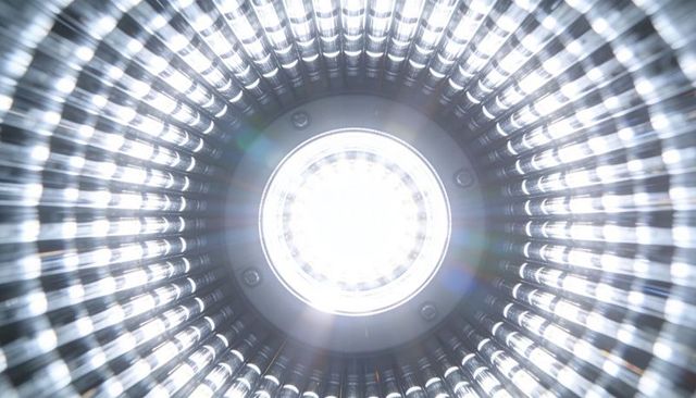 High-intensity circular led emitter emitting starburst flare inside ribbed reflector housing