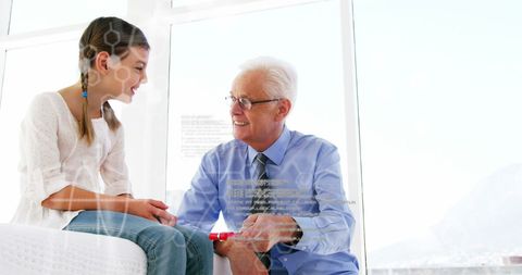 Senior Doctor Engaging Young Girl in Modern Medical Office