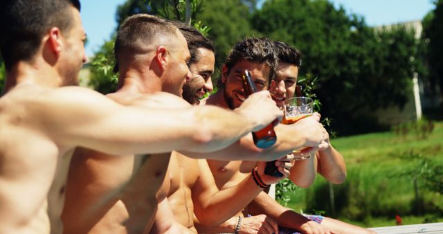 Friends Cheering and Drinking Beer Outdoors at a Poolside Party - Download Free Stock Images Pikwizard.com