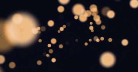 Abstract Glowing Light Dots over Black Background