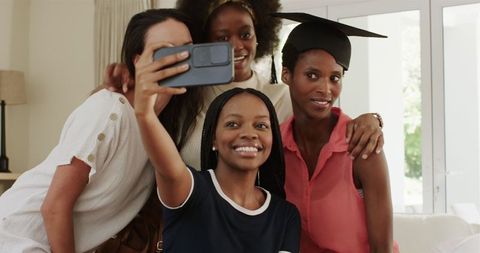 Diverse Female Friends Celebrating Graduation with Joyful Selfie