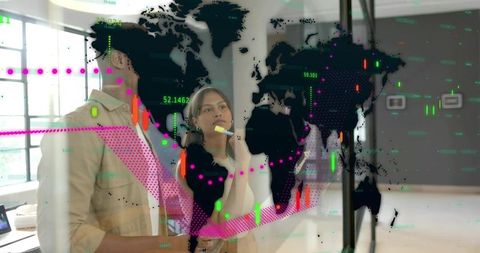 Colleagues analyzing global data on glass wall with colorful charts and digital dashboard