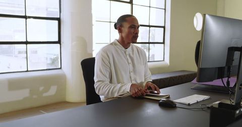 Focused business professional reviewing notes in modern office