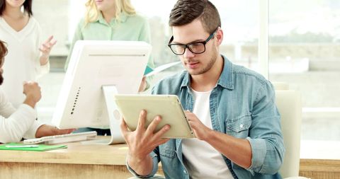 Young Professional Working on Tablet in Modern Office - Download Free Stock Images Pikwizard.com