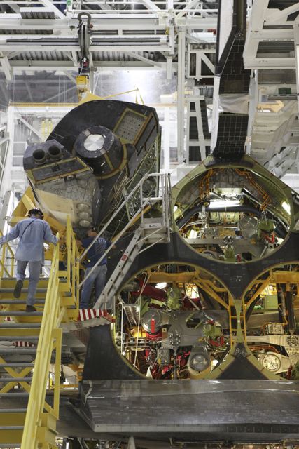 Technicians Installing Space Shuttle Endeavour's OMS Pod in Processing Facility - Download Free Stock Images Pikwizard.com