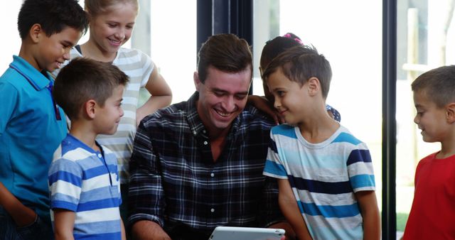 Male Teacher Engaging with Students Using Tablet in Classroom - Download Free Stock Images Pikwizard.com