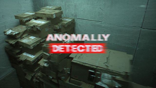 Anomaly Detected Glitch Overlay on Stacked Damaged Cardboard Boxes in Concrete Storage Room