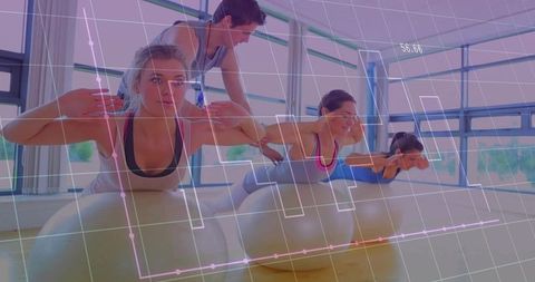 Instructor adjusting postures during exercise ball workout