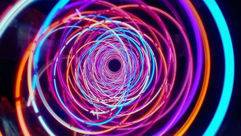 Swirling neon spiral tunnel with braided led light trails immersive kinetic installation