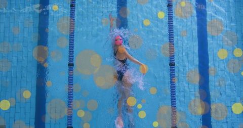 Female athlete executing front crawl in clear blue pool