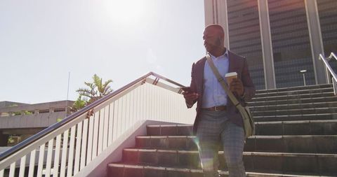 Businessman Walking in Urban Environment with Coffee and Phone