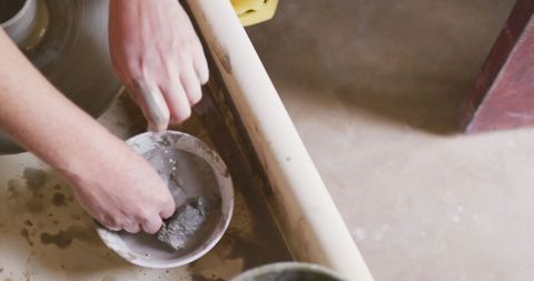 Closeup of Potter Hands Crafting Ceramic Bowl on Wheel