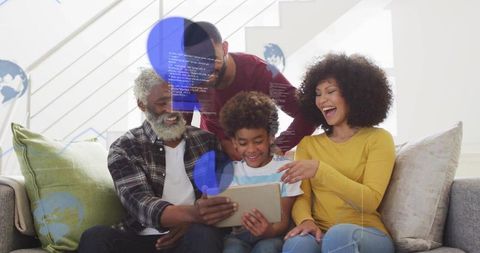 Smiling multigenerational family gathered around tablet sharing laughter and bonding at home