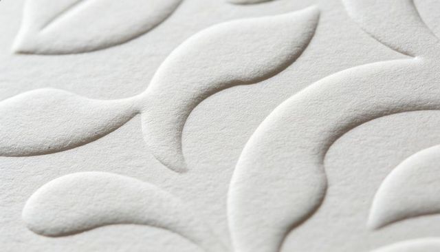 Embossed White Paper with Raised Floral Teardrop Motif Macro Texture for Elegant Design