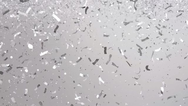 Falling silver confetti with glitter dust and chrome foil sparkle for celebration