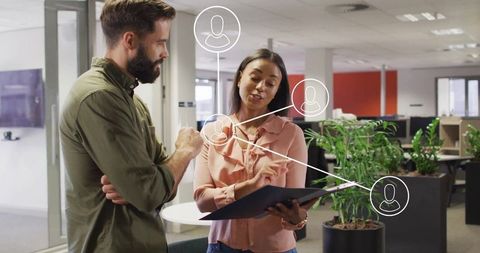 Diverse Coworkers Collaborating on Digital Projects in Modern Office