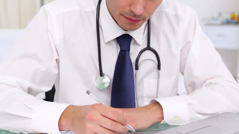 Professional Doctor Writing Notes in Office Setting