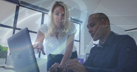 Female Leader Guiding Colleague at Laptop Collaborating on Data Dashboard and Analytics