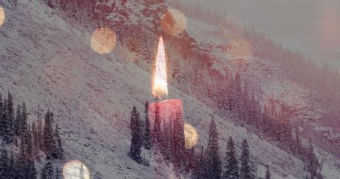 Serene winter landscape with glowing candle