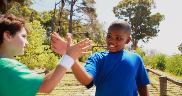 Two Boys High-Fiving Outdoors in Summer - Download Free Stock Images Pikwizard.com