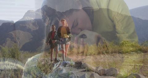 Double exposure hiking couple on arid mountain trail blending with woman cuddling dog