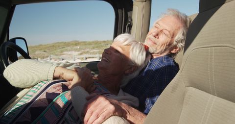 Senior Couple Relaxing in Car Enjoying Beach Sunrise