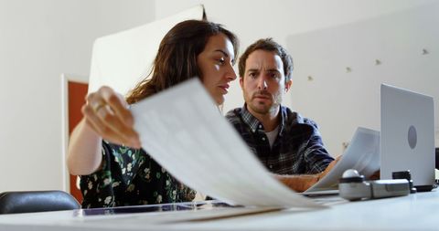 Focused employees analyzing business documents together