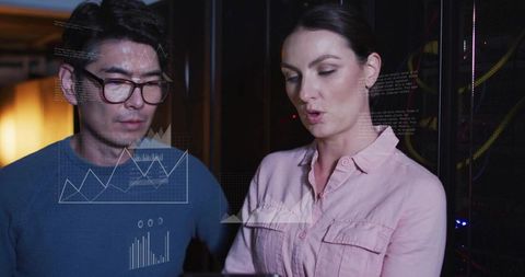 IT Professionals Analyzing Data in a Server Room Environment