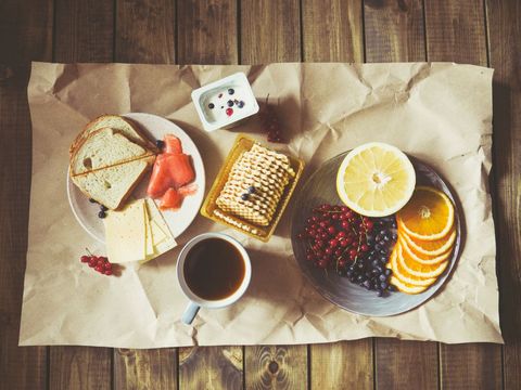Rustic Breakfast with Bread, Fruits and Coffee on Rustic Table