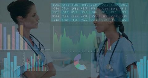 Two clinicians reviewing patient data with AR analytics overlay in hospital corridor