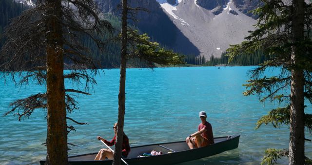 People Canoeing in Tranquil Mountain Lake with Blue Water - Download Free Stock Images Pikwizard.com