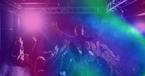 Crowd-surfing enthusiast in energetic nightclub atmosphere