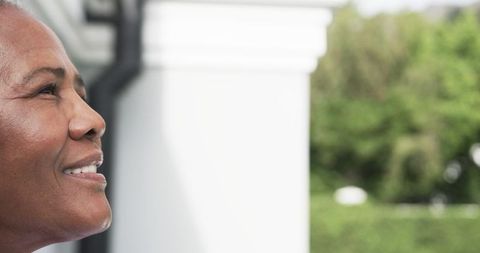Smiling Senior Woman Enjoying Outdoors in Mountains