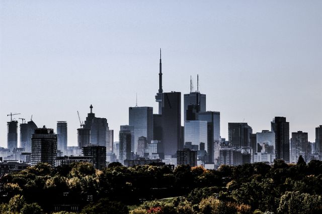 This image of a modern city skyline against a clear sky is perfect for promoting urban life, modern architecture, and business hubs. It can be used for travel websites, business presentations, real estate advertisements, and articles featuring city development and infrastructure. Suitable for illustrating concepts such as progress, economic growth, and modern living.