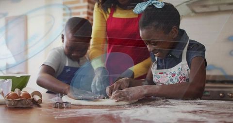 Mother guiding kids shaping dough and cutting cookies while baking in cozy kitchen