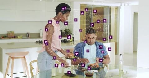 Serving woman placing plate on glass dining table with purple social network overlay