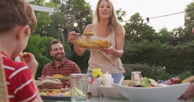 Family Dinner Outdoors with Mother Serving Food to Family Members - Download Free Stock Images Pikwizard.com