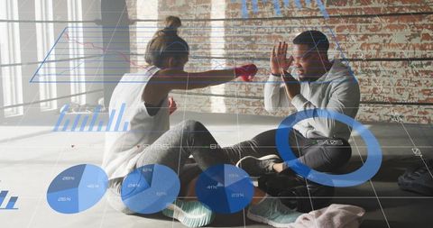 Couple sparring in industrial loft gym with digital fitness data overlays and analytics