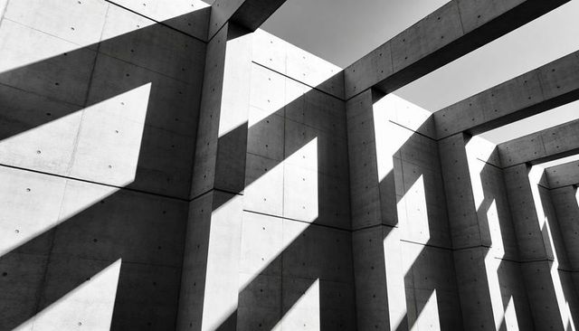 Monochrome Concrete Colonnade Casting Geometric Shadows, Minimalist Modernist Architecture