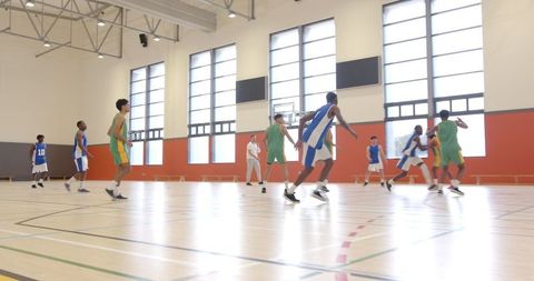 Dynamic Basketball Game Indoors with Energetic Team Play
