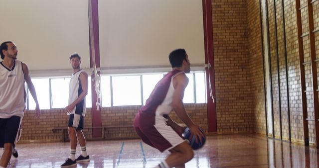 Basketball Players Competing Indoors in Brick Wall Gym - Download Free Stock Images Pikwizard.com