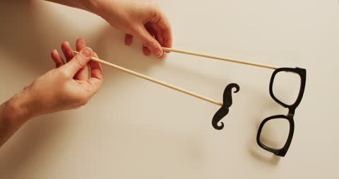 Hands Holding Party Props Moustache and Glasses